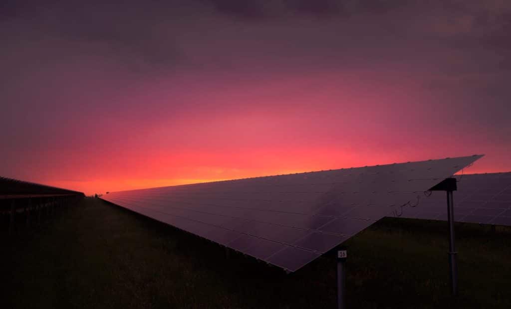 A solar panel at sunrise showing the need for storage and renewable energy